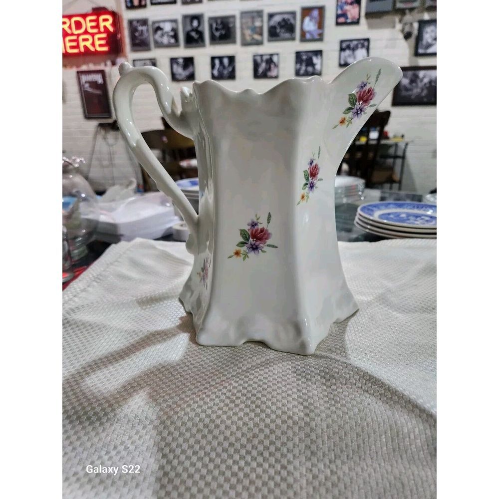 Vintage ceramic creamy white pitcher with Handpainted floral bouquets . size is